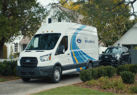 A white Ford Mobile Service van parked in a driveway near a house