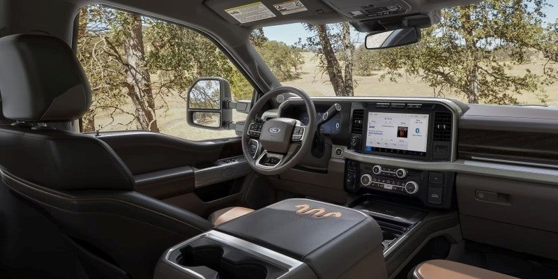 Ford truck interior featuring steering wheel, touchscreen display